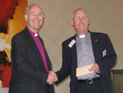 Archbishop Alan Harper presents the runner up award in the Diocesan Magazine category for Connor Connections to Archdeacon Stephen McBride.